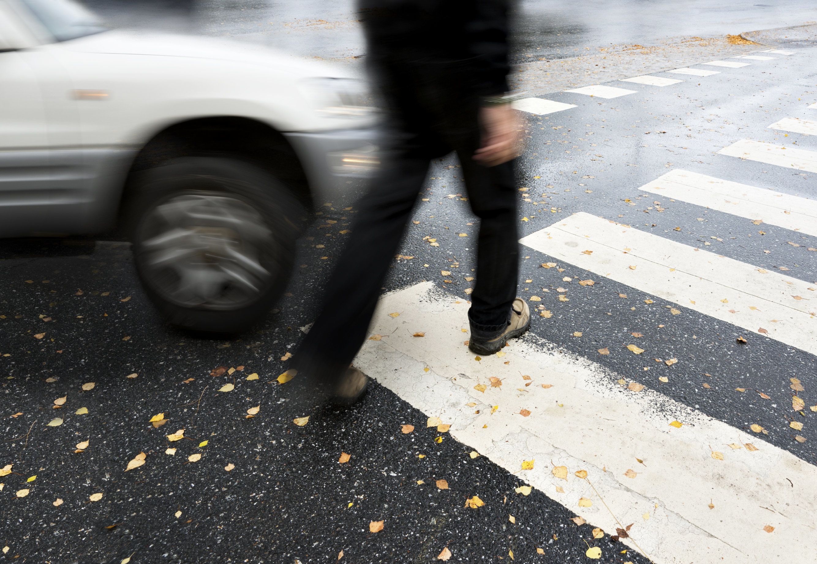 A car turning into a pedestrian at a crosswalk 