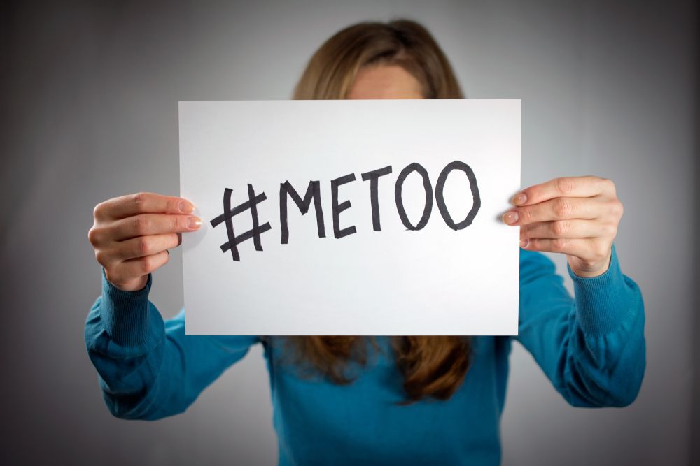 Sexual abuse victim holding "me too" sign