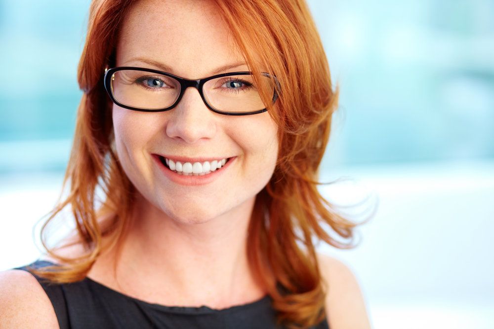 Smiling redheaded woman with glasses