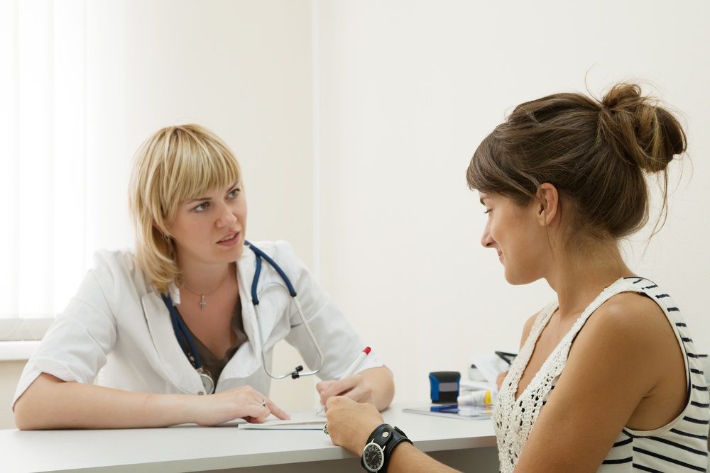 A woman talking with a doctor