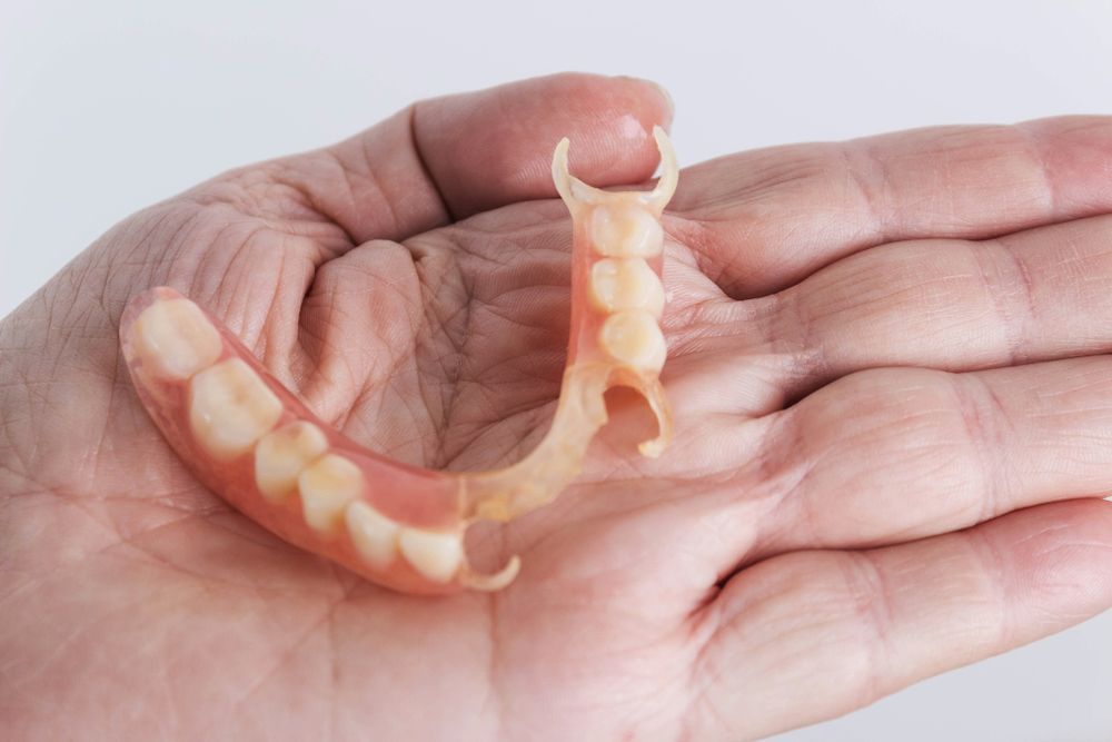 Dental bridge held in palm of hand