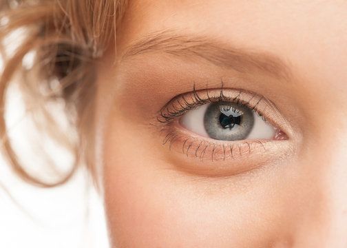 A closeup view of a woman's grayish-blue eye.