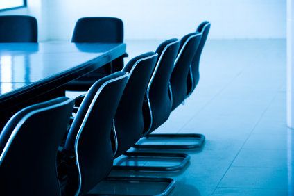 Empty chairs lined up in conference room