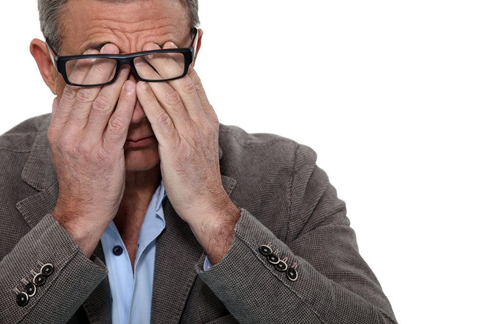 Man rubbing eyes