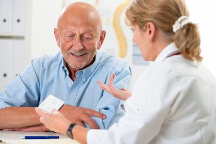 Doctor discussing treatment options with elderly patient