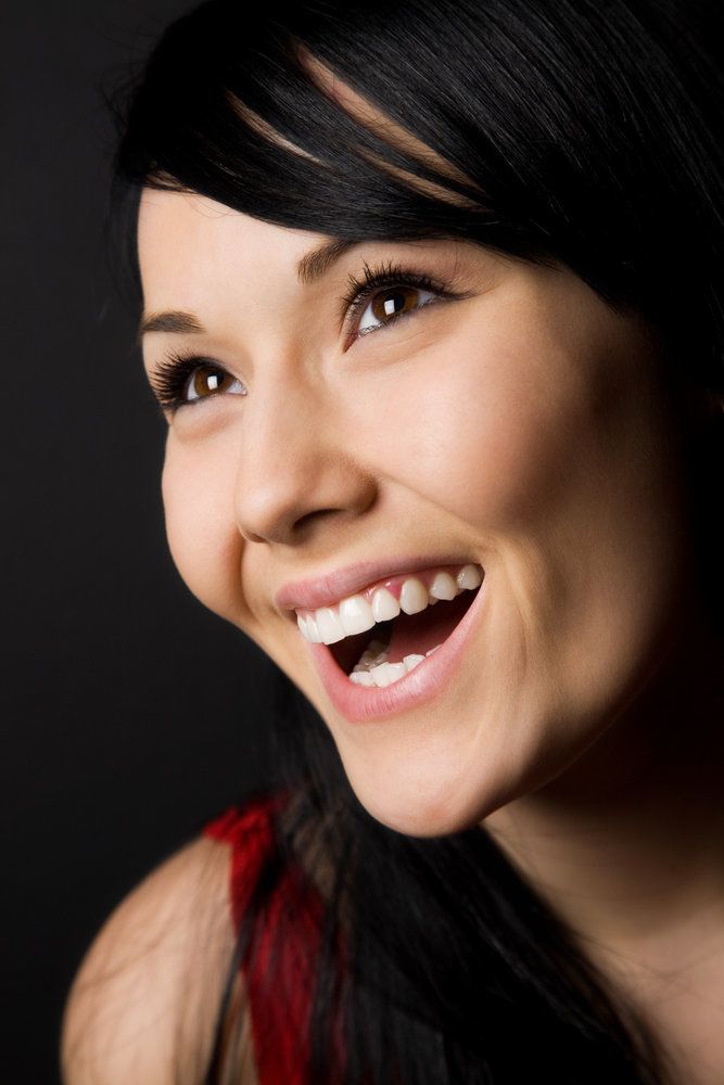 Portrait of woman smiling on dark background