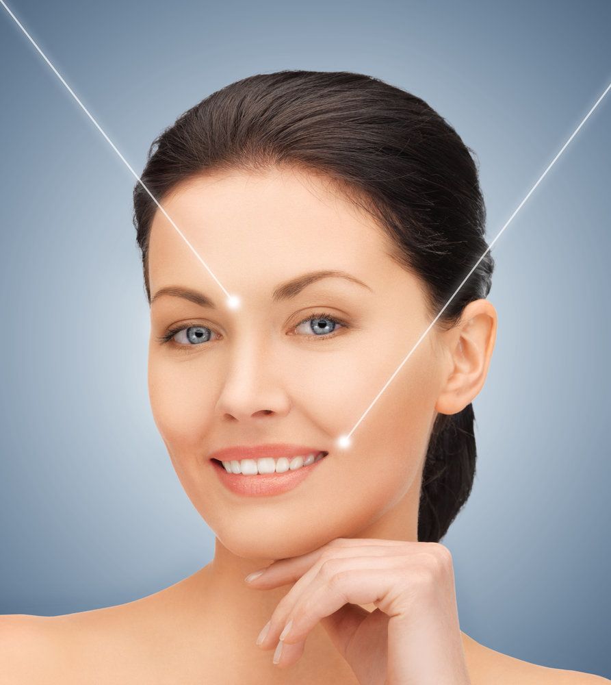 woman smiling with light pointing to forehead and mouth