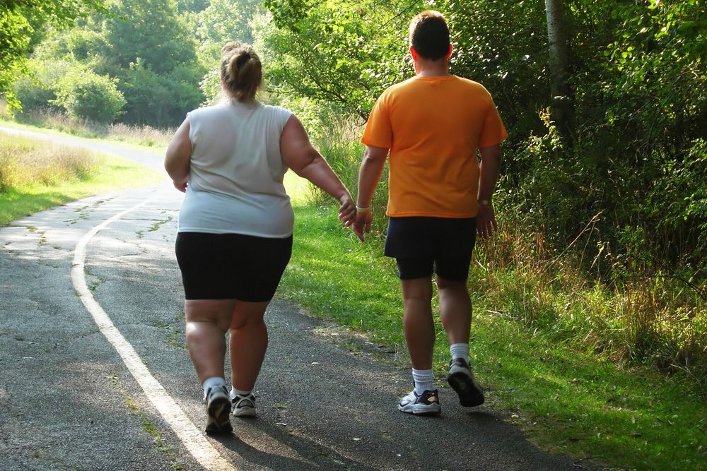 Man and woman exercising in the park after gastric sleeve surgery