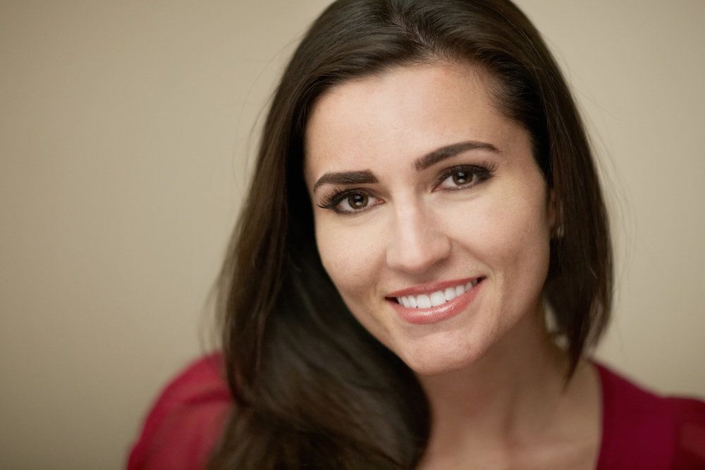 A dark-haired woman with a white smile