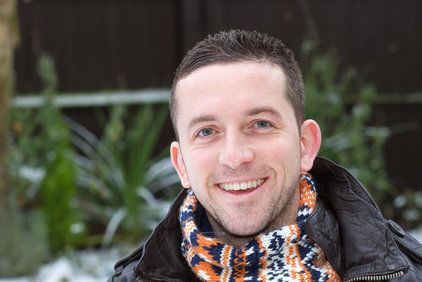 Smiling man wearing scarf outdoors