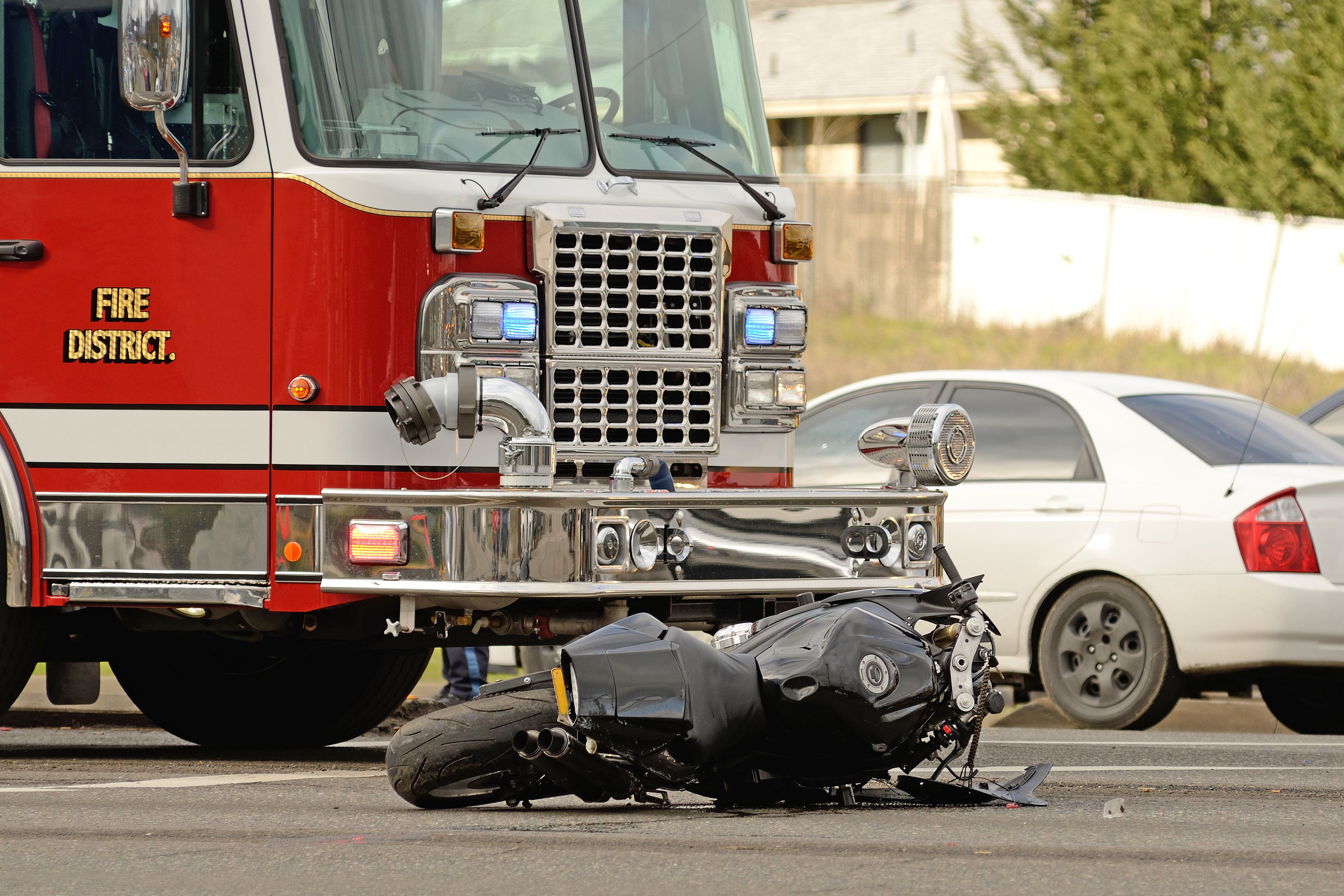 A crashed motorcycle and a firetruck