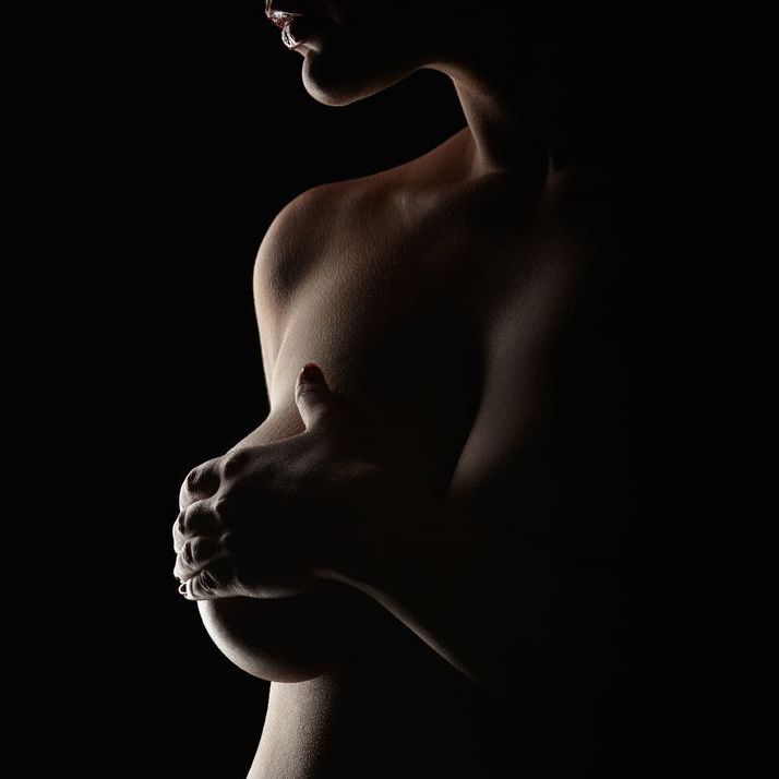 Woman holding naked breast