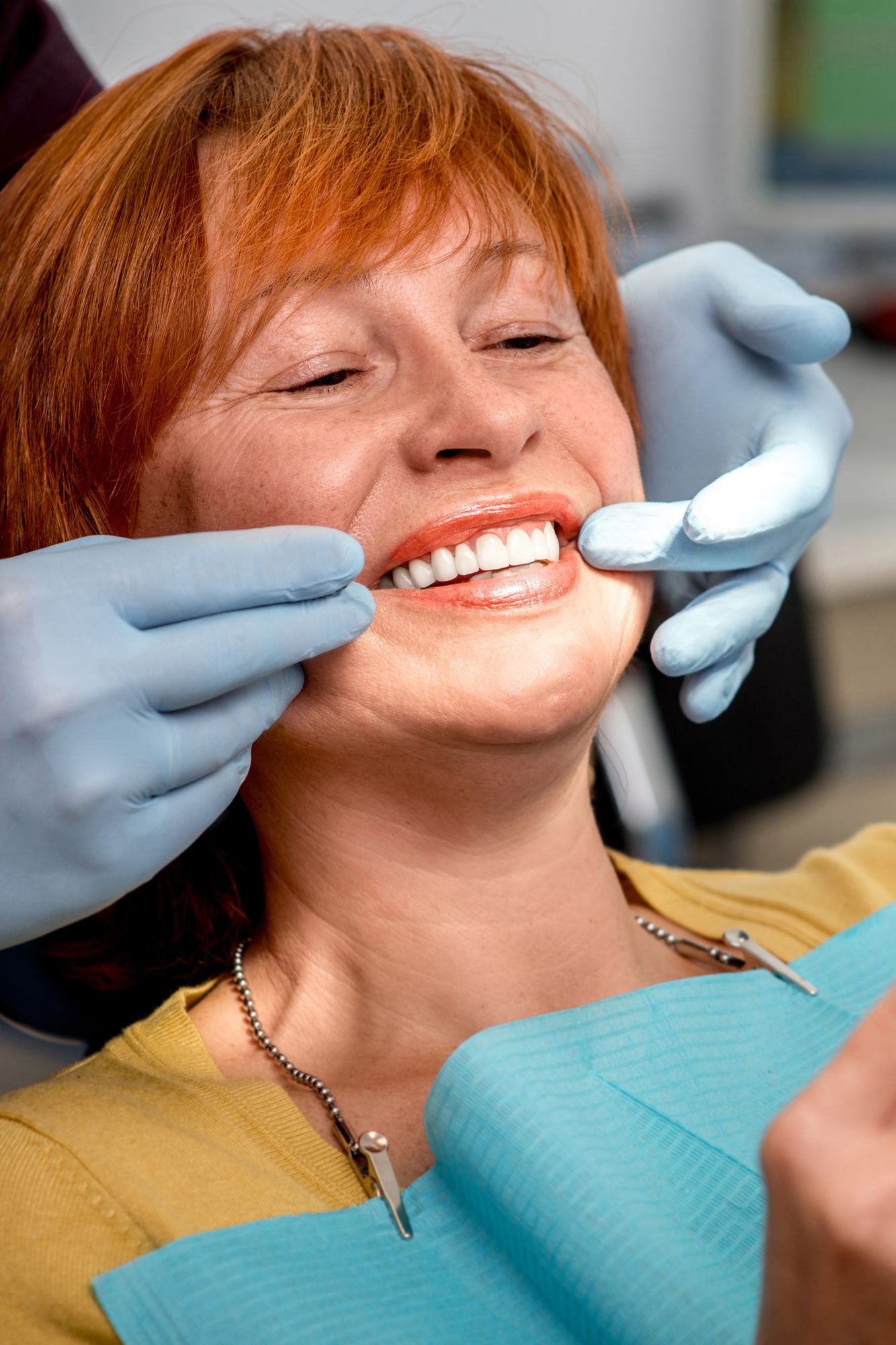 Photo of a woman smiling in a dentist chair