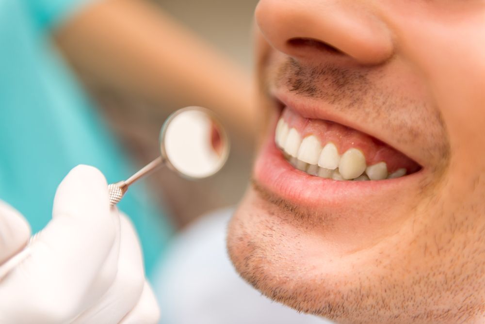 A dentist examining a man