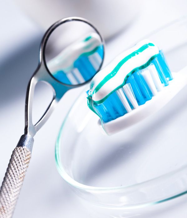 Dentist's mirror and toothbrush with toothpaste