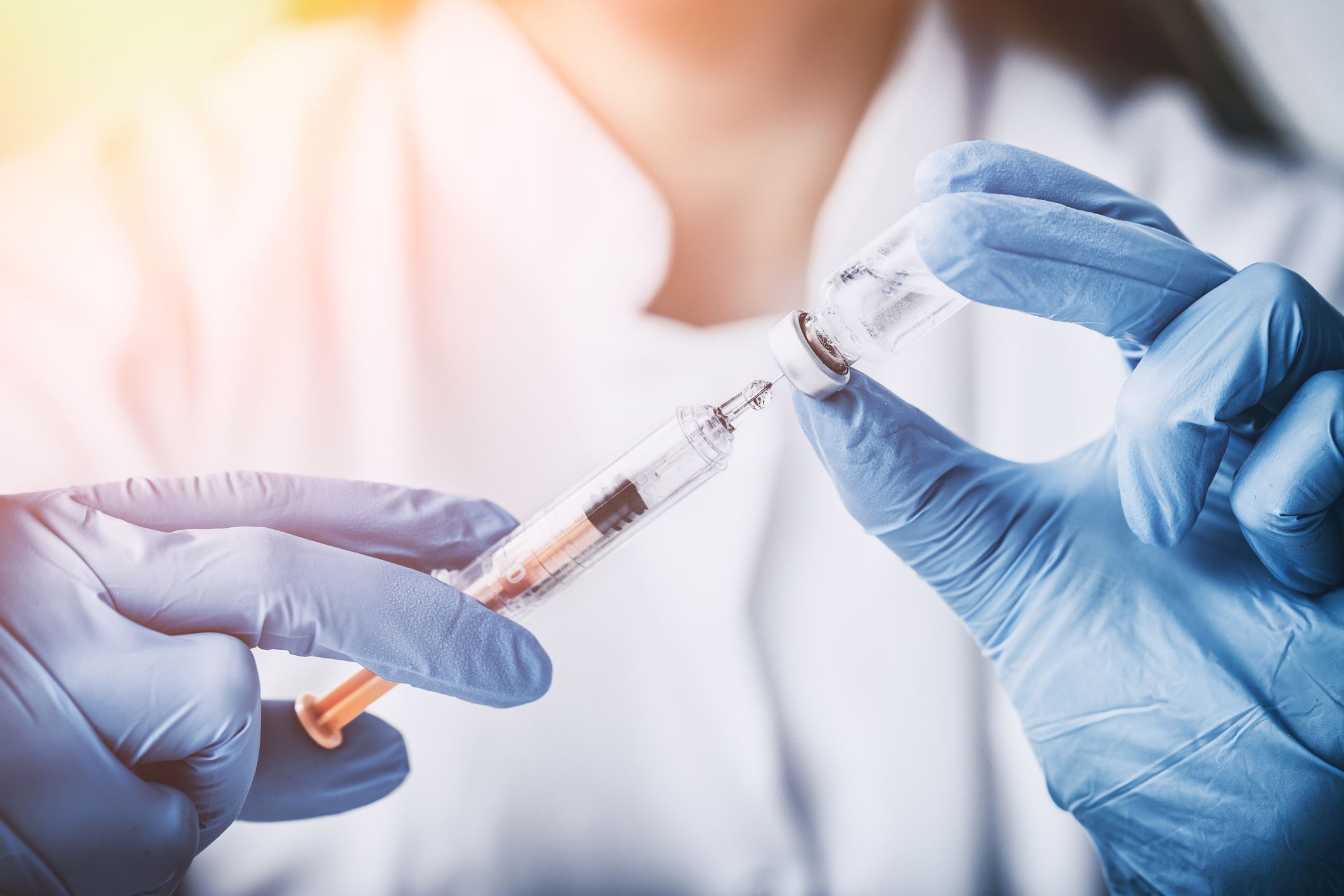 Technician filling syringe with fluid