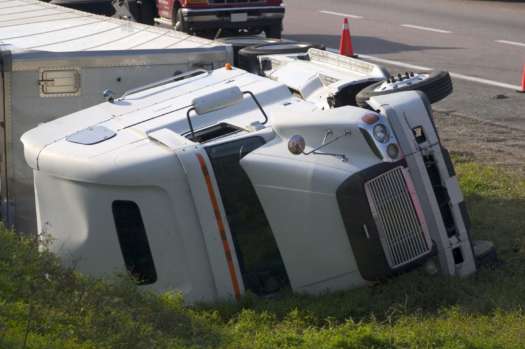 An overturned big-rig in the aftermath of a trucking accident