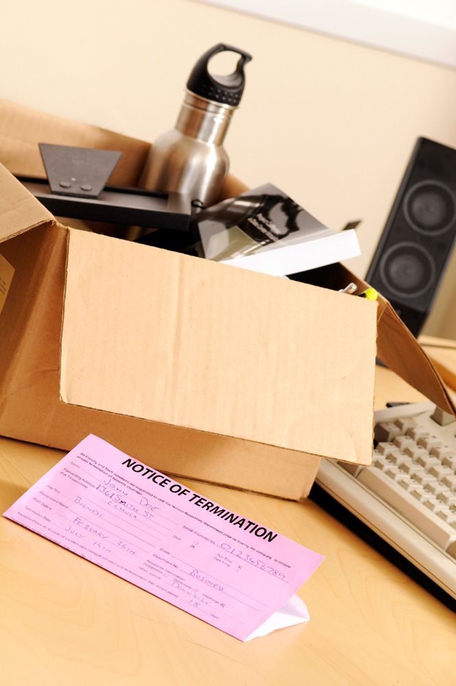 A pink slip and a box of stuff after workplace termination