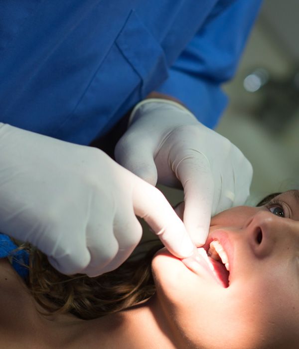 Photo of a woman receiving an oral exam