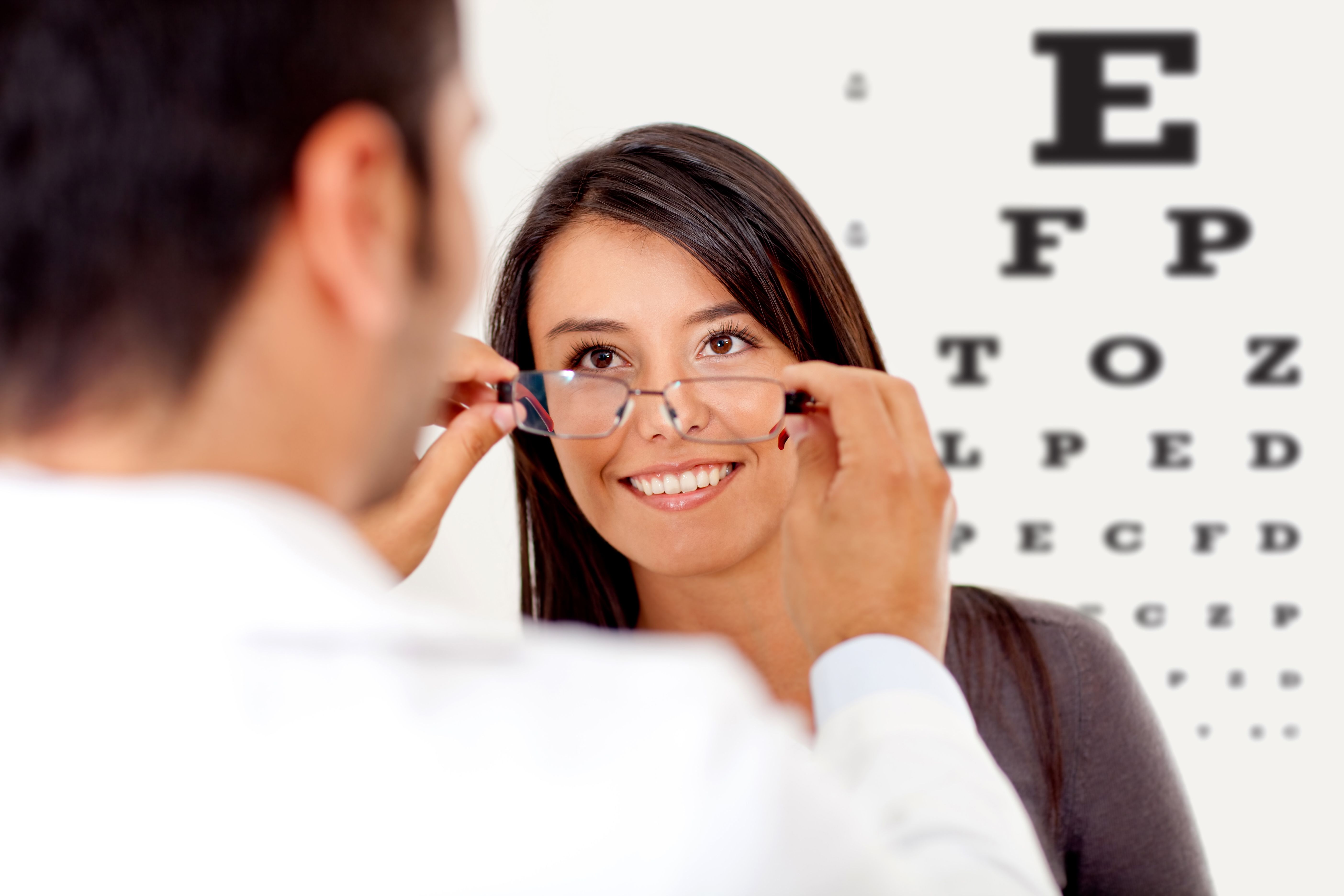 Optician holding a patient's frames