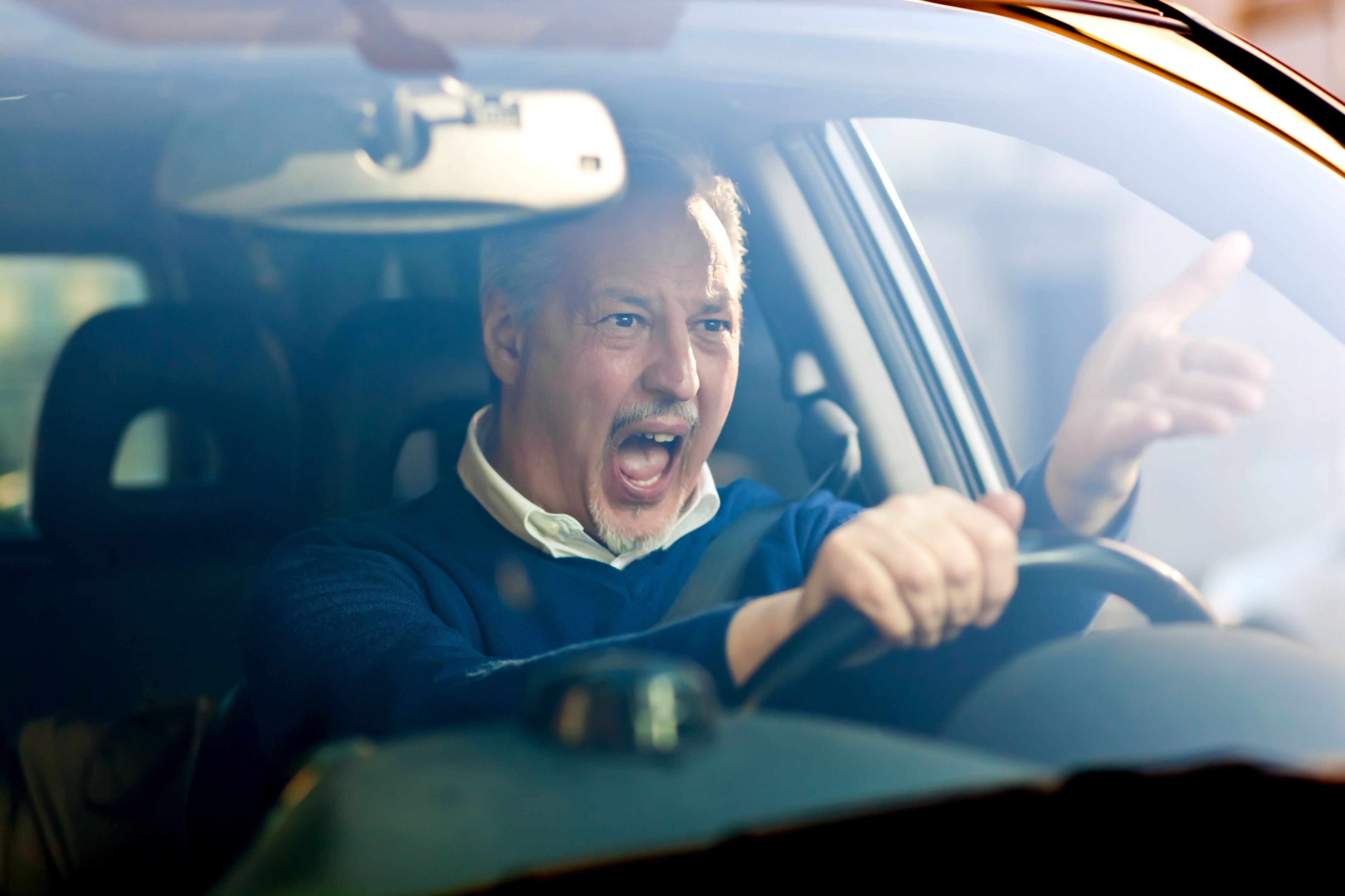 A man yelling while driving