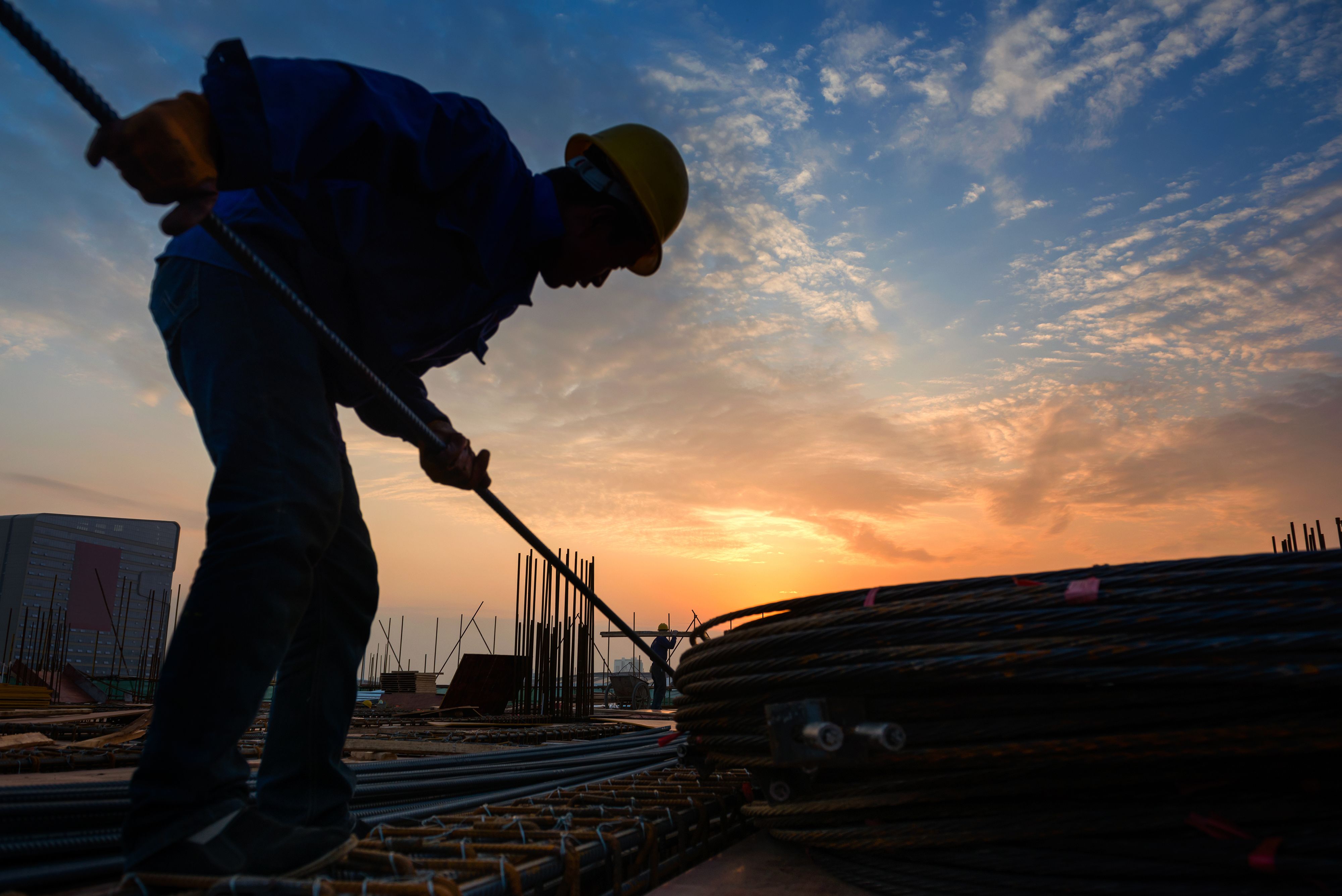 An iron worker performing his job duties