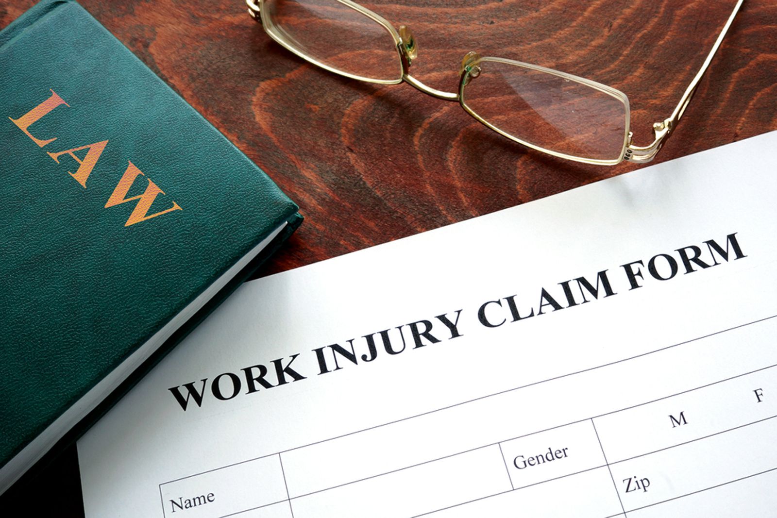 law book and work injury claim form