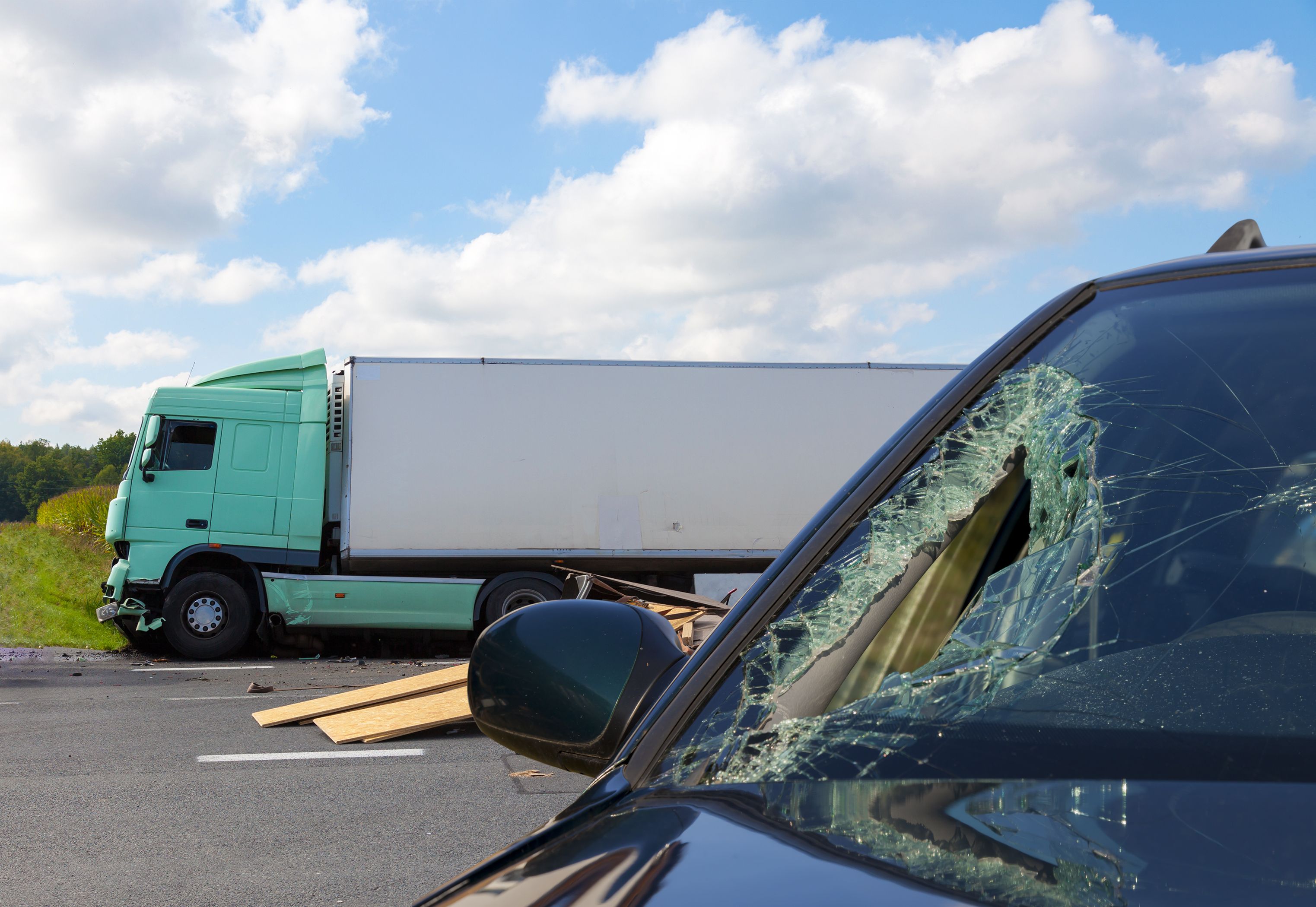 shattered windshield with semi-truck
