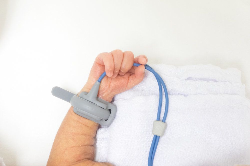 Medical monitoring device attached to newborn baby