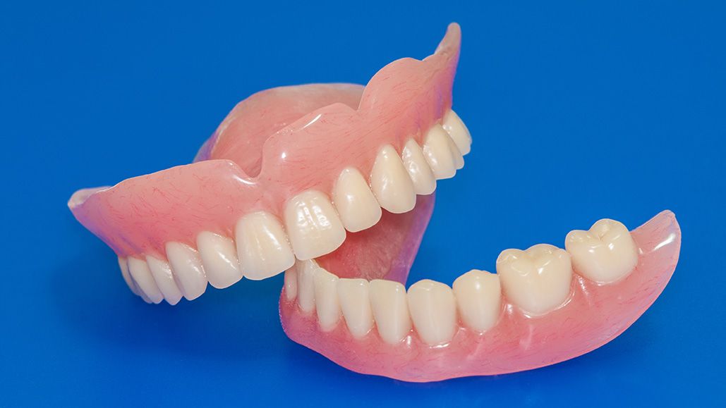 A set of full upper and lower dentures