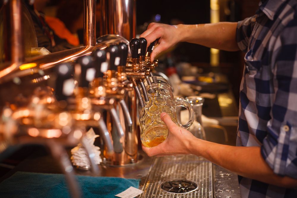 a bartender pouring a beer