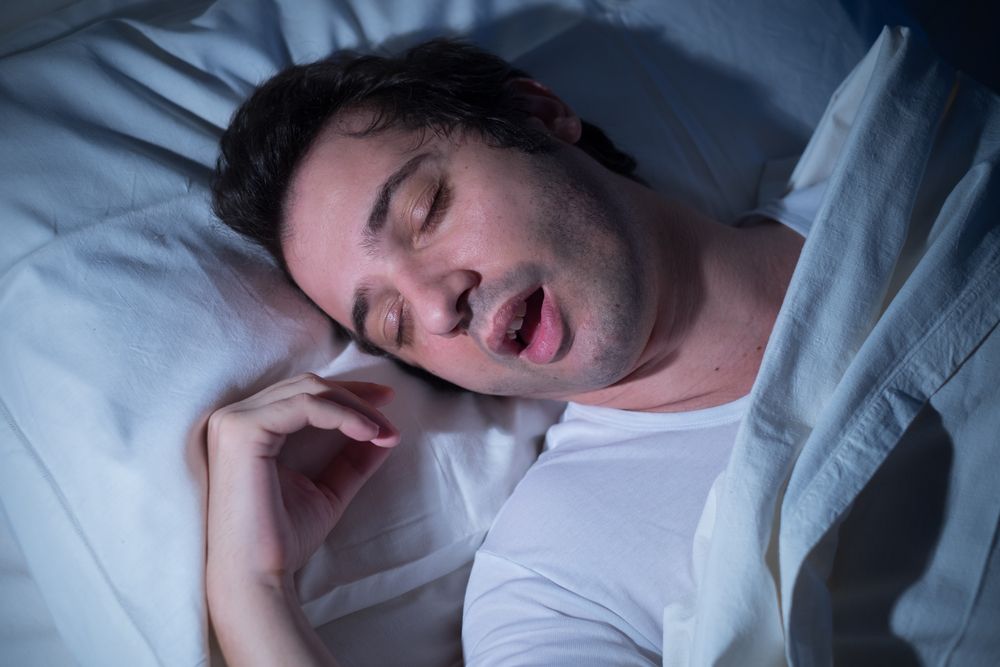 Man snoring in bed