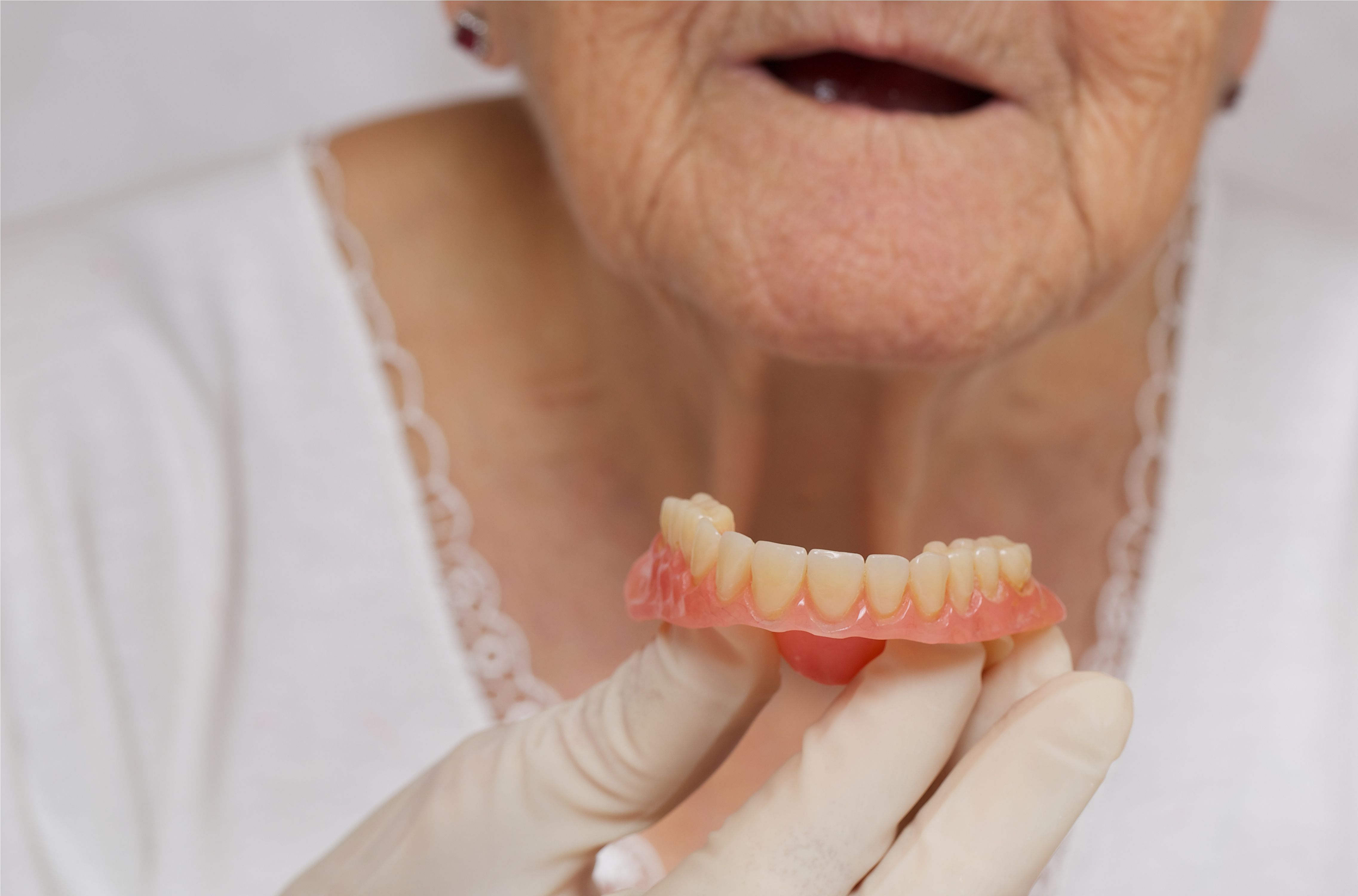 dentures and a woman without teeth