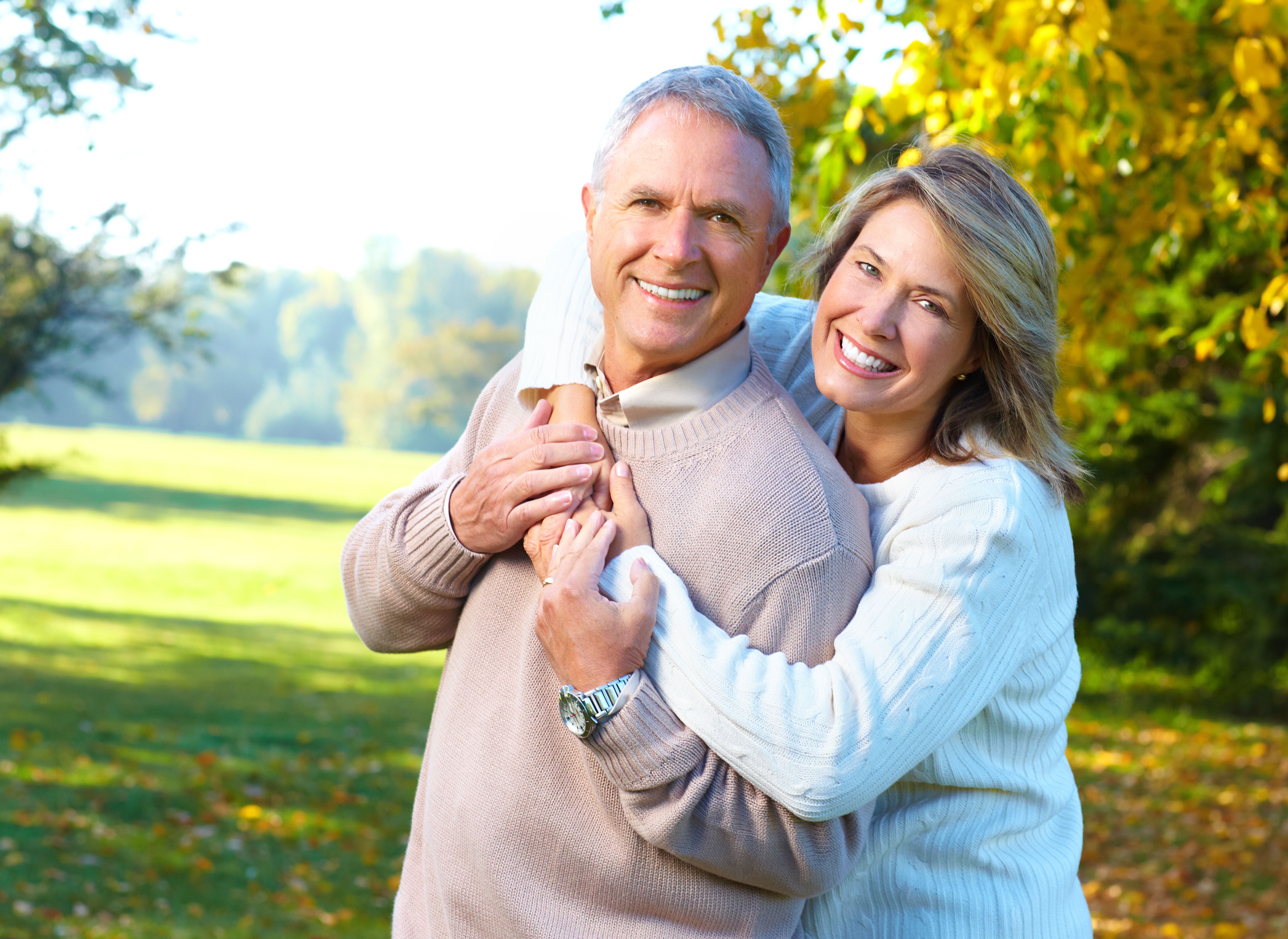 Middle-aged couple smiles to show two attractive rows of white teeth