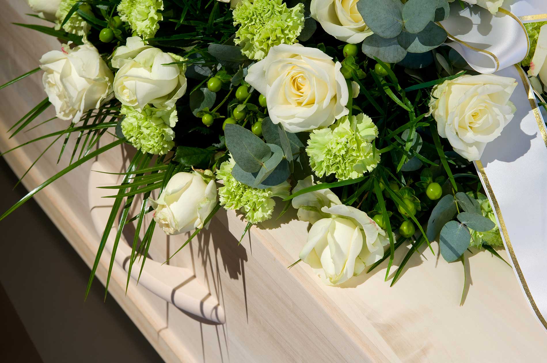Flowers on top of a casket